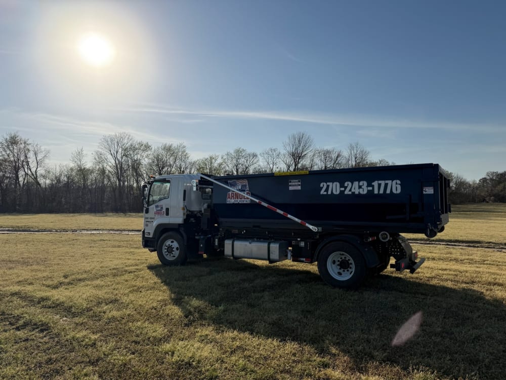 Arnold Roll Off Rentals truck hauling a dumpster